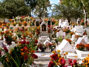 Cemeteries are decorated with flowers and candles.