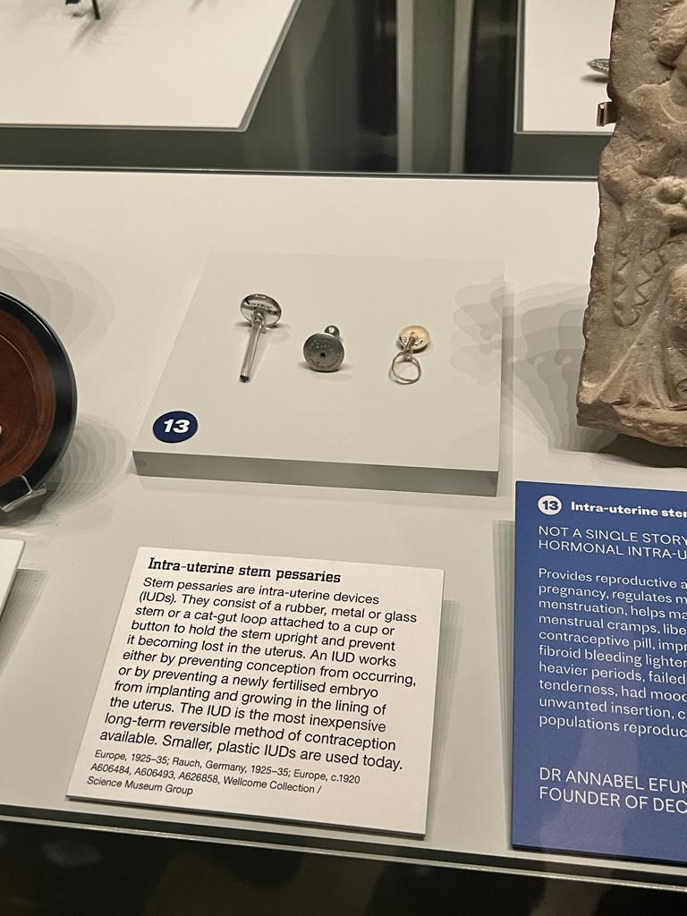 Photo from the author, of an IUD in the Medicine Man exhibit in London. 3 different types of IUDs are in this photo, rubber, glass, or metal. 